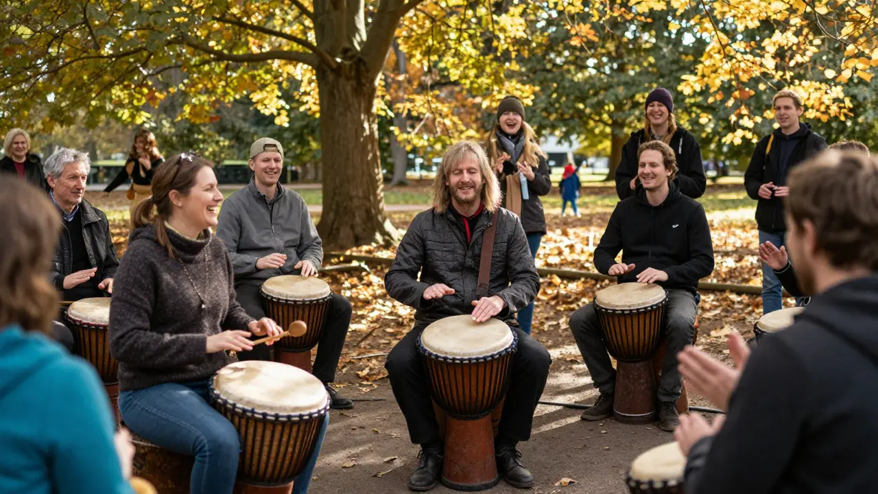 A diverse group drumming in Clissold Park under autumn trees, people playing drums, buckets, and clapping together.